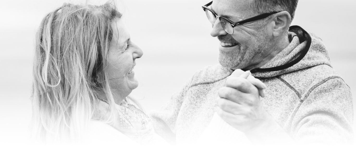 An Aged Man and Woman Holding Hands, Looking at Each Other and Smiling